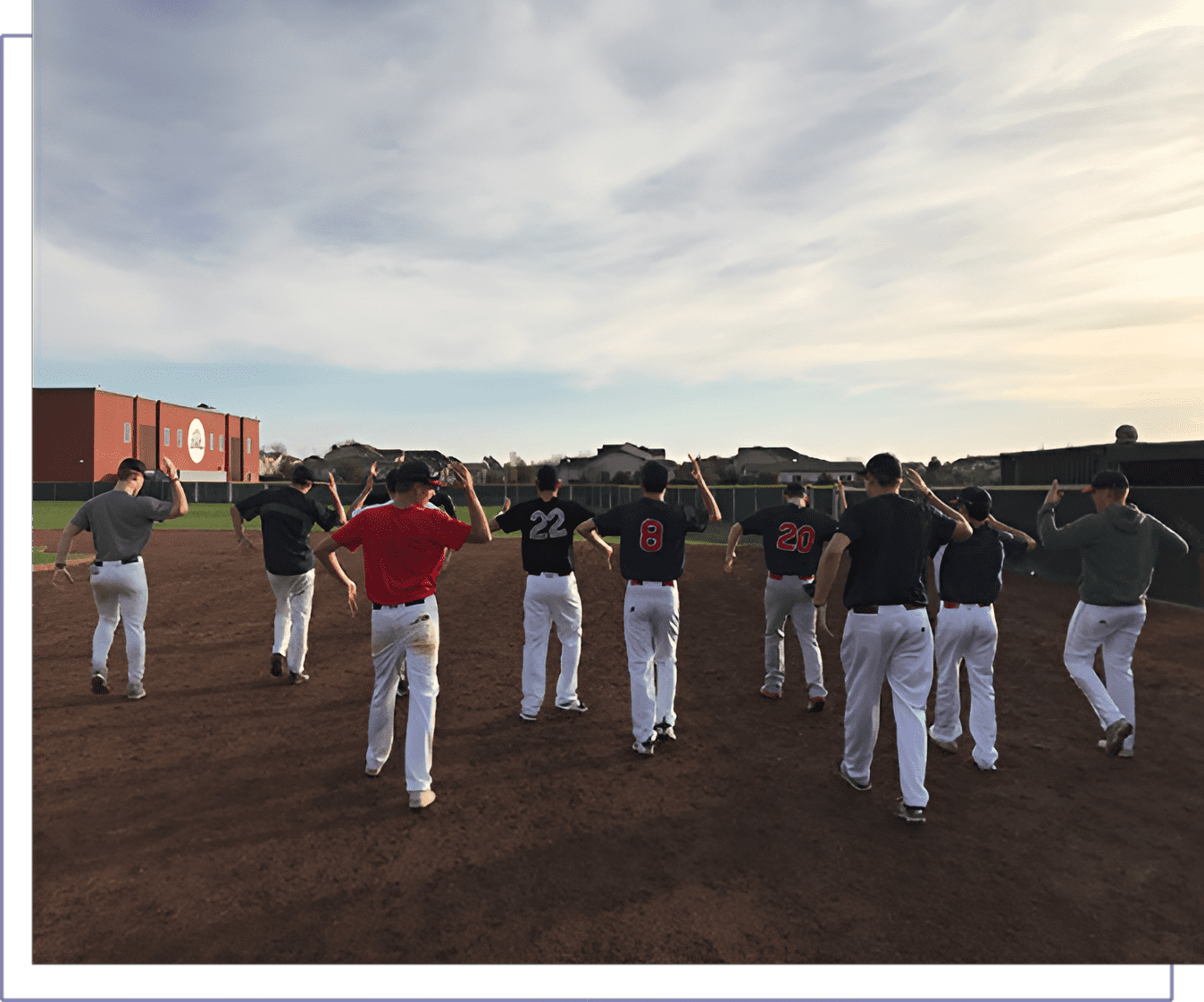 A group of baseball players standing on top of a field.