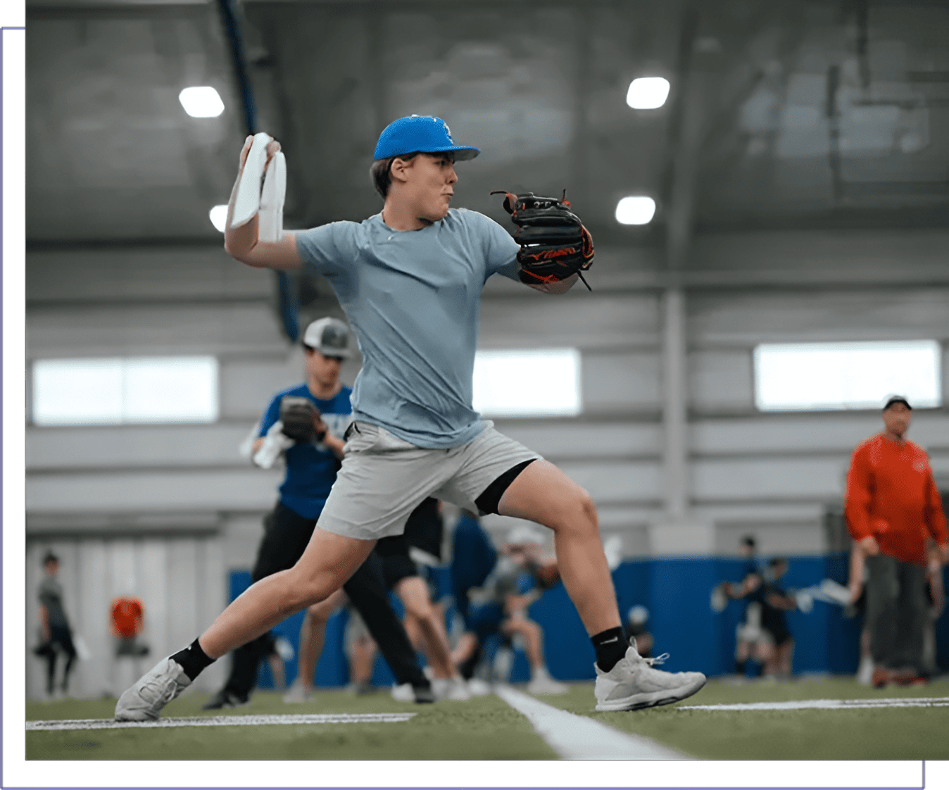 A man in blue shirt and gray shorts playing frisbee.